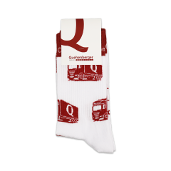White sports socks with red Quehenberger truck motifs, upper edge is red with white lettering “Close to your business.”